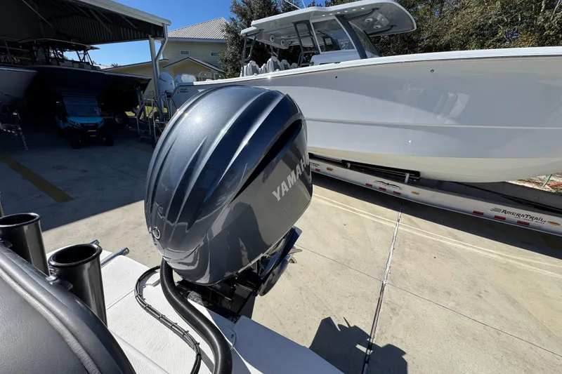 Slide: The Image of 2026 Sea Born LX24 Center Console with Yamaha outboard motor in a marina setting. - 37