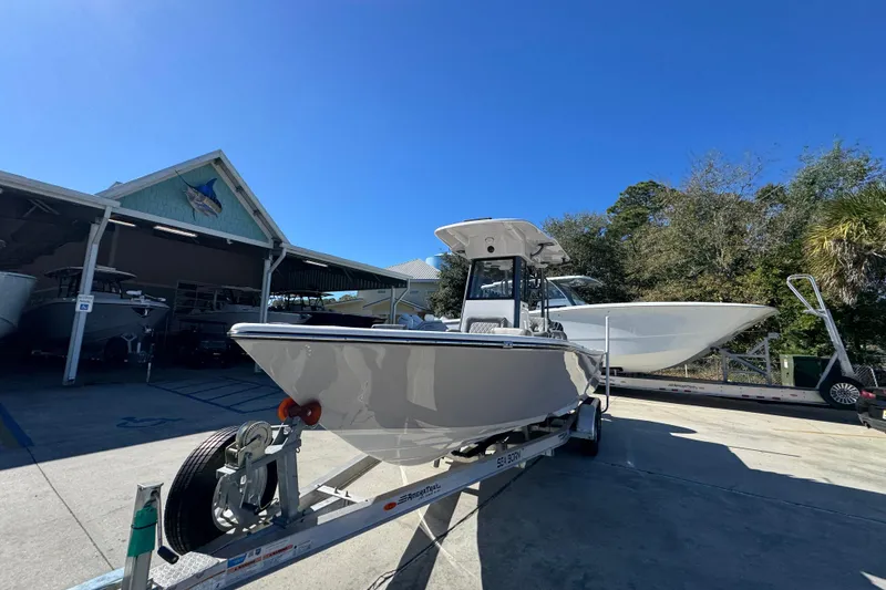 Slide: The Image of 2026 Sea Born LX24 Center Console boat on trailer under clear blue sky. - 4
