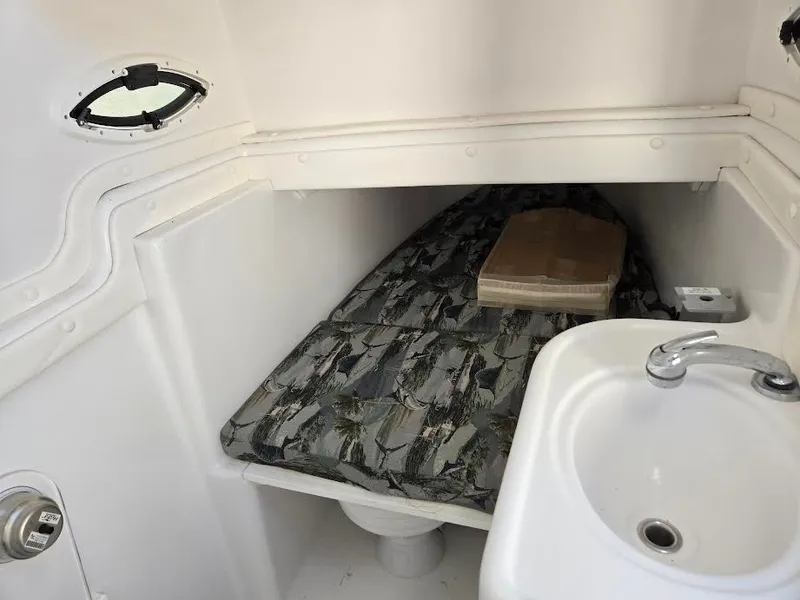 Slide: The Image of Interior of Century 3200 boat, 2024 model, featuring bed and sink. - 20