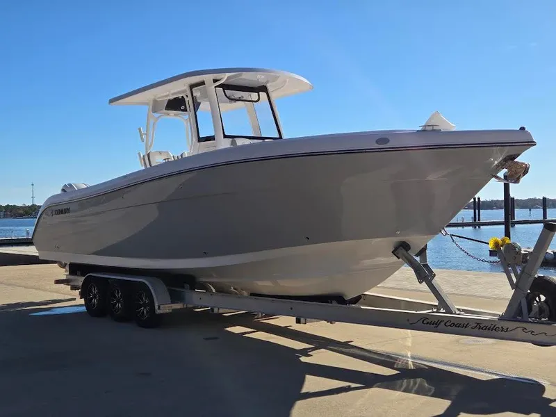 Slide: The Image of 2024 Century 3200 boat on trailer by the water. - 4