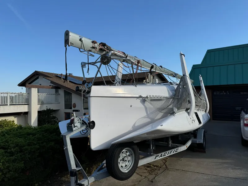 Slide: The Image of Corsair 760 sailboat on trailer, parked in residential driveway, 2023 model. - 1