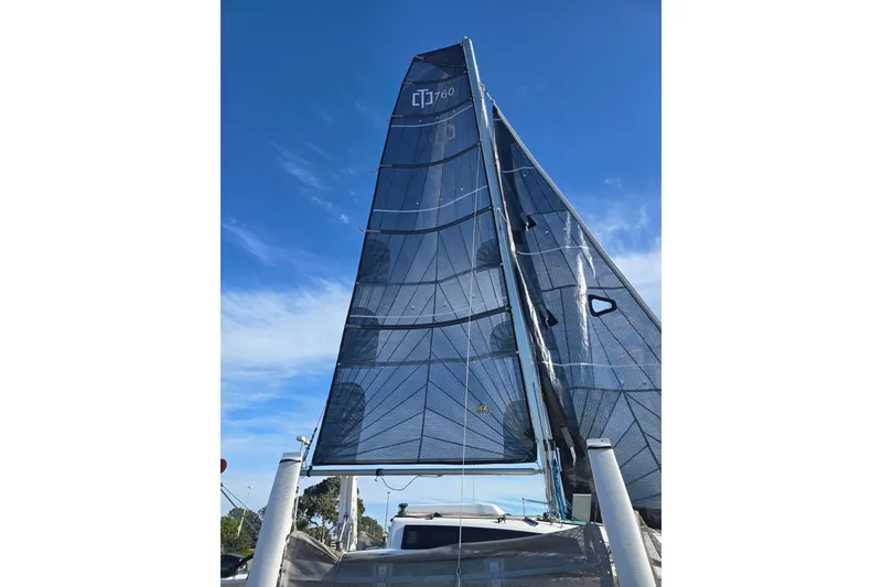 Slide: The Image of Red fuel tank on a 2023 Corsair 760 sailboat deck, with ropes and cables. - 11