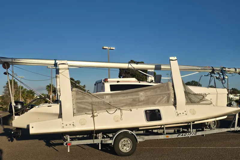 Slide: The Image of 2023 Corsair 760 sailboat on trailer, parked in residential driveway. - 12