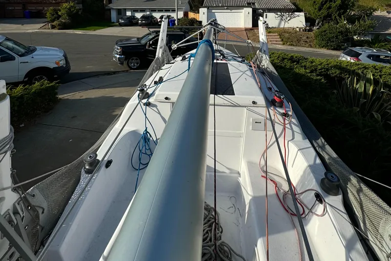Slide: The Image of 2023 Corsair 760 sailboat on trailer, parked in residential driveway. - 3