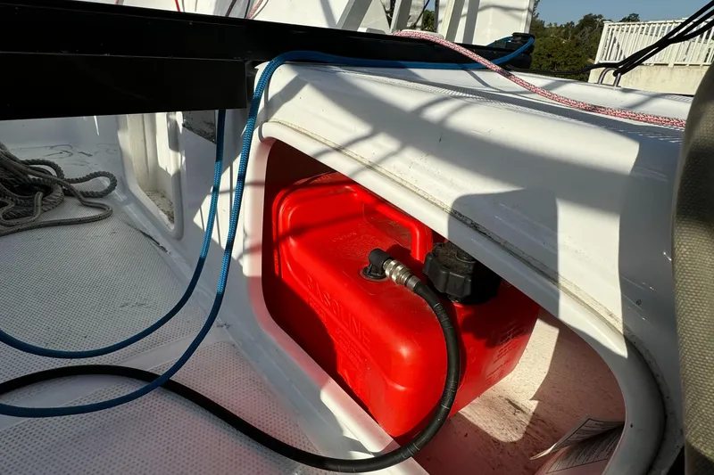Slide: The Image of Red fuel tank on a 2023 Corsair 760 sailboat deck, with ropes and cables. - 6