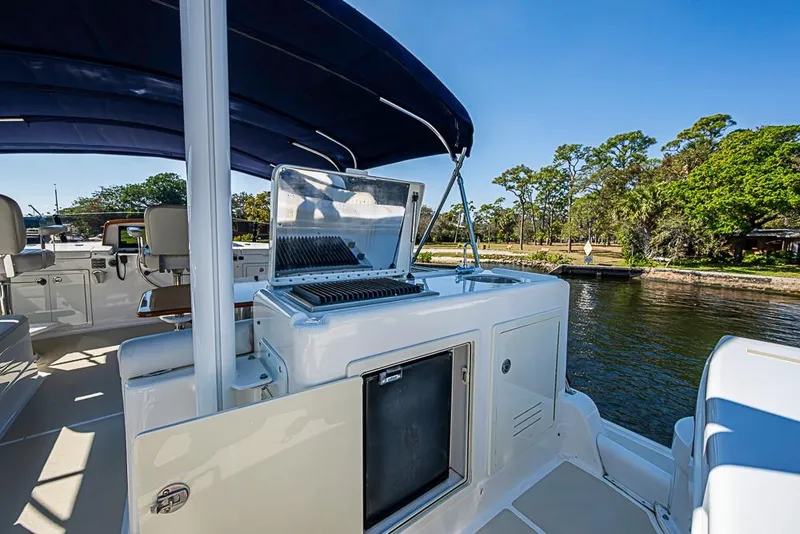 Slide: The Image of 2013 Grand Banks 43 Europa yacht with outdoor grill and seating area by the water. - 2