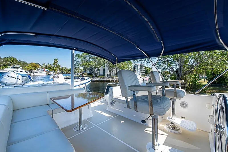Slide: The Image of Luxurious 2013 Grand Banks 43 Europa yacht interior with seating and helm, docked by the water. - 21