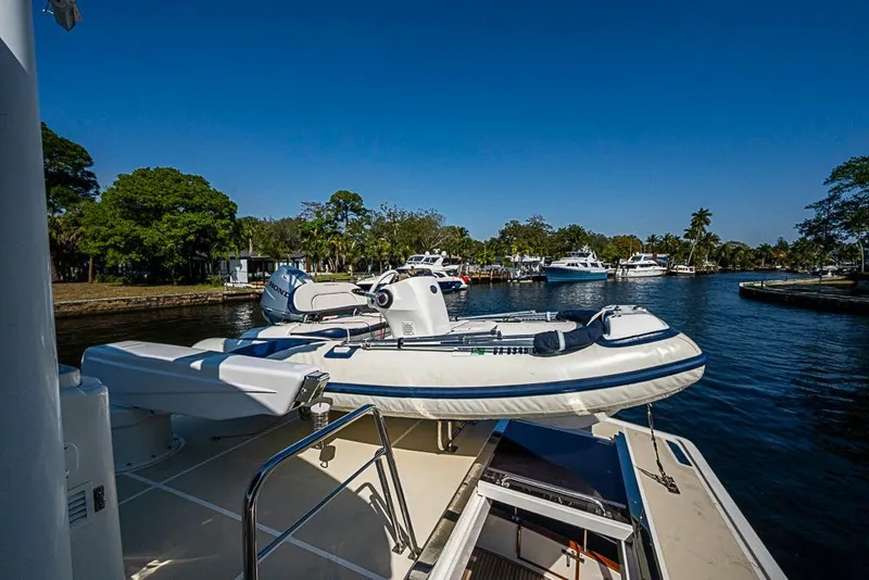 Slide: The Image of 2013 Grand Banks 43 Europa yacht with inflatable boat on deck, docked in scenic marina. - 26
