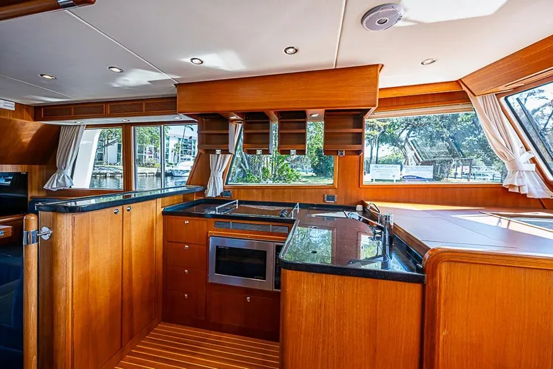 Slide: The Image of Luxurious 2013 Grand Banks 43 Europa yacht interior with modern kitchen and wood finish. - 38