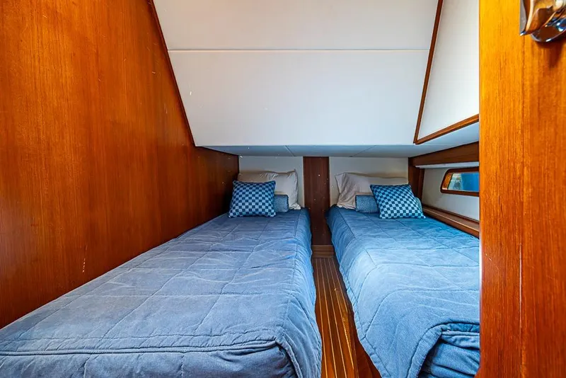 Slide: The Image of Cabin interior of 2013 Grand Banks 43 Europa with twin beds and blue bedding. - 53