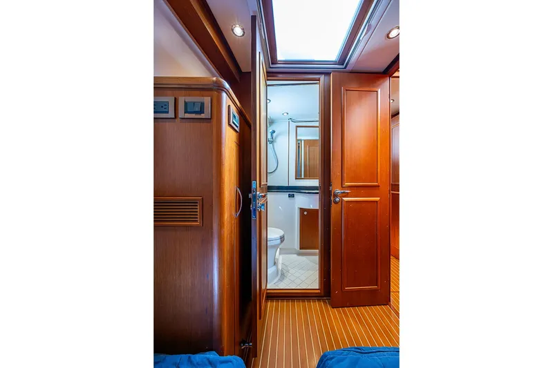 Slide: The Image of Interior of 2013 Grand Banks 43 Europa yacht, featuring wooden cabinetry and a compact bathroom. - 56