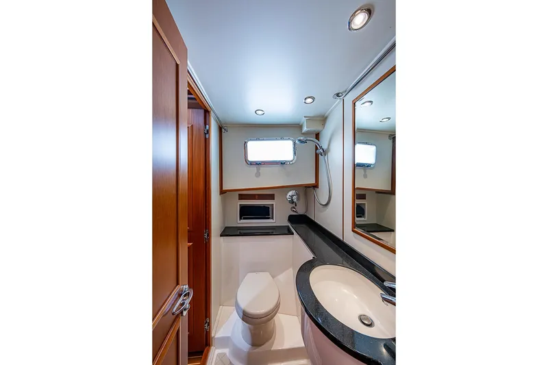 Slide: The Image of Luxurious bathroom in 2013 Grand Banks 43 Europa yacht, featuring modern fixtures and wood accents. - 57
