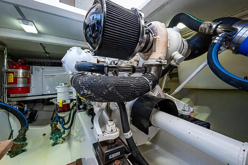 Slide: The Image of Engine room of 2013 Grand Banks 43 Europa yacht, showcasing mechanical components and fire safety equipment. - 64
