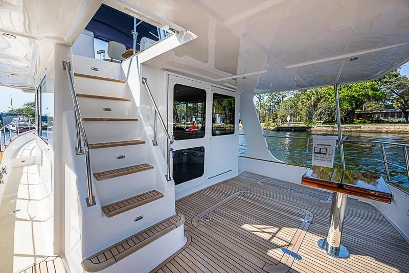 Slide: The Image of 2013 Grand Banks 43 Europa yacht deck with stairs and scenic water view. - 8