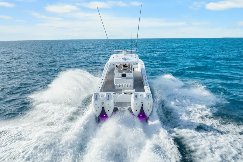 Slide: The Image of Freeman 47 boat cruising on open sea, 2099 model, powerful engines visible. - 12