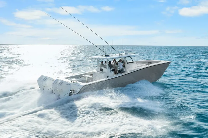 Slide: The Image of Freeman 47 boat cruising on open sea, 2099 model, under clear blue sky. - 13