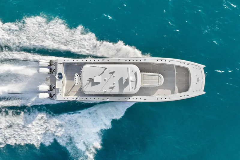 Slide: The Image of Aerial view of Freeman 47 boat cruising on turquoise water, 2099 model. - 15