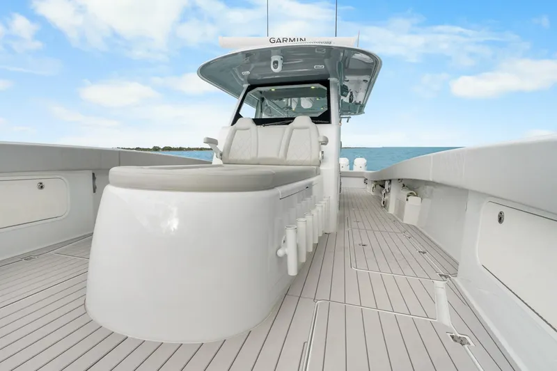 Slide: The Image of Freeman 47 boat deck, modern design, spacious seating, ocean view, clear sky, 2099 model. - 18
