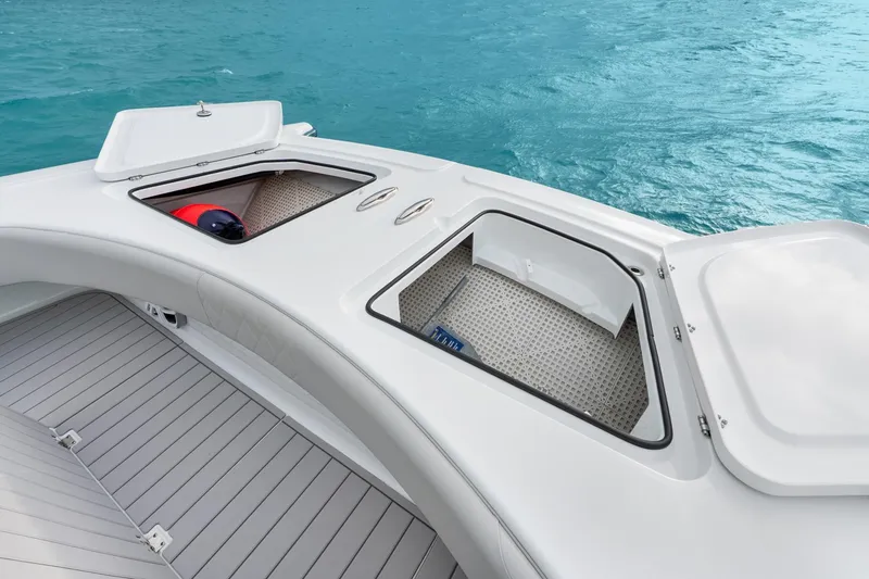 Slide: The Image of Freeman 47 boat deck with open storage compartments, 2099 model, on clear blue water. - 20