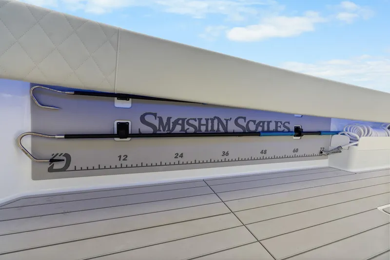 Slide: The Image of Fishing rod holder on Freeman 47 boat, featuring "Smashin' Scales" branding and measurement scale. - 33