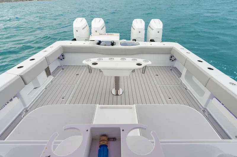 Slide: The Image of Freeman 47 boat deck with modern design, featuring multiple outboard motors, 2099 model. - 34