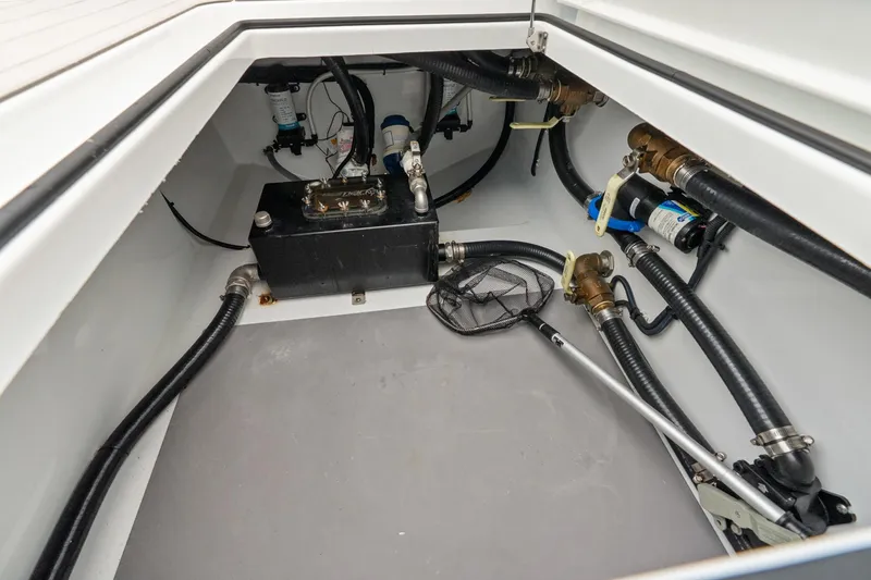 Slide: The Image of Interior view of Freeman 47 boat's mechanical compartment, showcasing pipes and equipment, year 2099. - 42