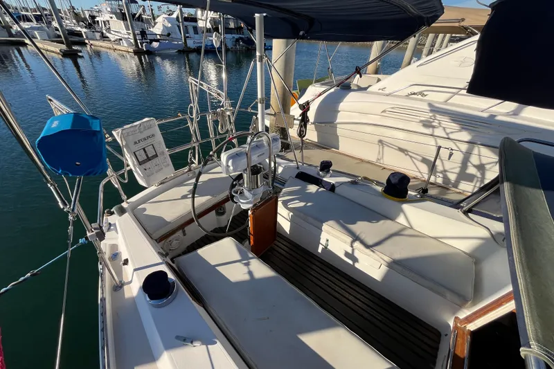 Slide: The Image of 1984 Catalina 36 MkII sailboat cockpit at marina, featuring seating and steering wheel. - 10