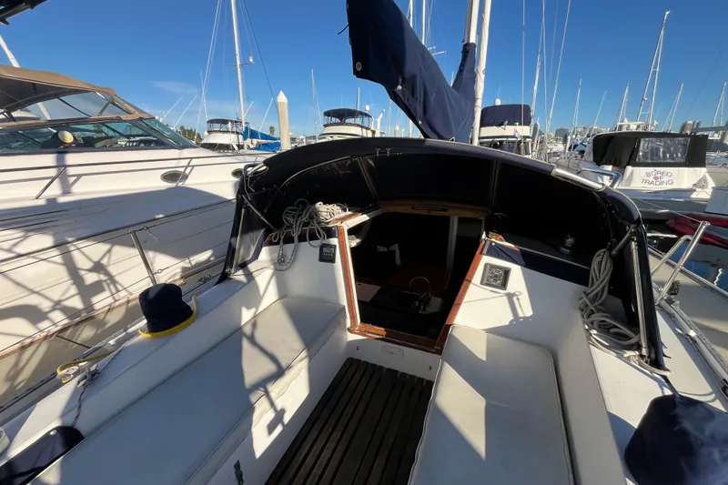 Slide: The Image of 1984 Catalina 36 MkII sailboat cockpit in marina, surrounded by other boats. - 18
