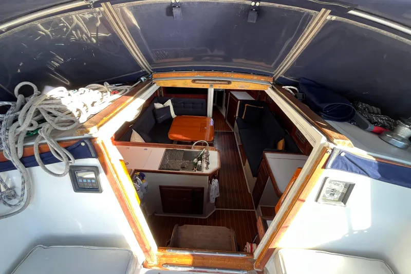 Slide: The Image of Interior view of 1984 Catalina 36 MkII sailboat, featuring cozy seating and compact kitchen area. - 19