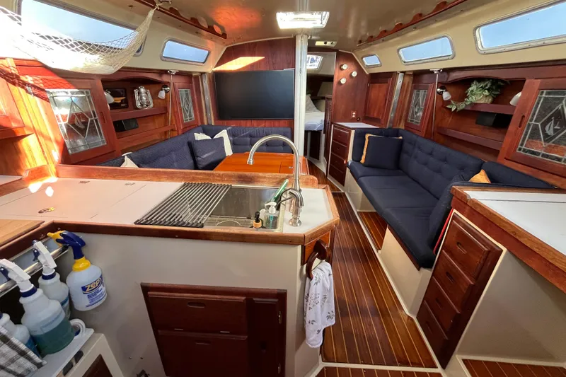 Slide: The Image of Interior of a 1984 Catalina 36 MkII sailboat with cozy seating and wooden cabinetry. - 21
