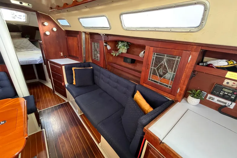 Slide: The Image of Interior of 1984 Catalina 36 MkII sailboat with cozy seating and wood accents. - 23