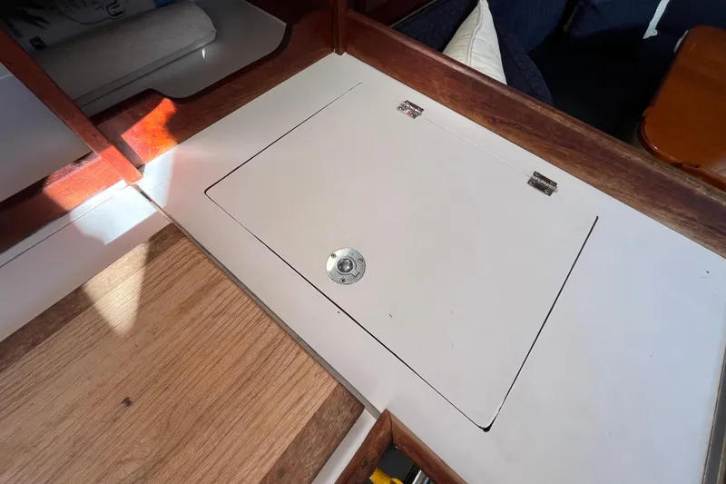 Slide: The Image of Interior view of a 1984 Catalina 36 MkII sailboat, featuring a wooden hatch cover. - 25