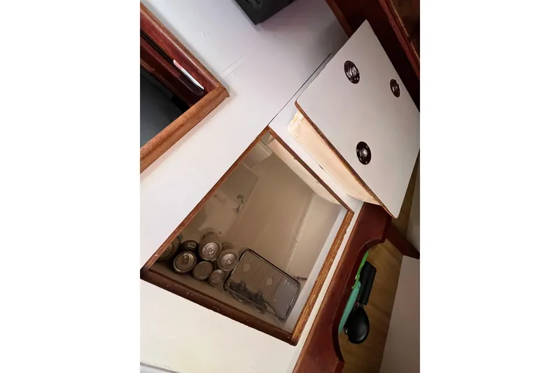 Slide: The Image of Interior storage compartment of 1984 Catalina 36 MkII sailboat with canned goods. - 26