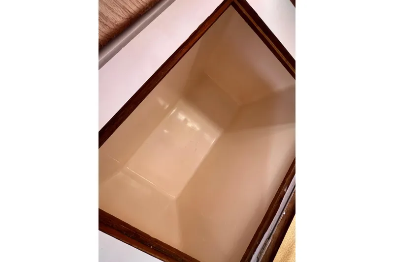 Slide: The Image of Open storage compartment on 1984 Catalina 36 MkII sailboat, featuring wooden trim. - 29