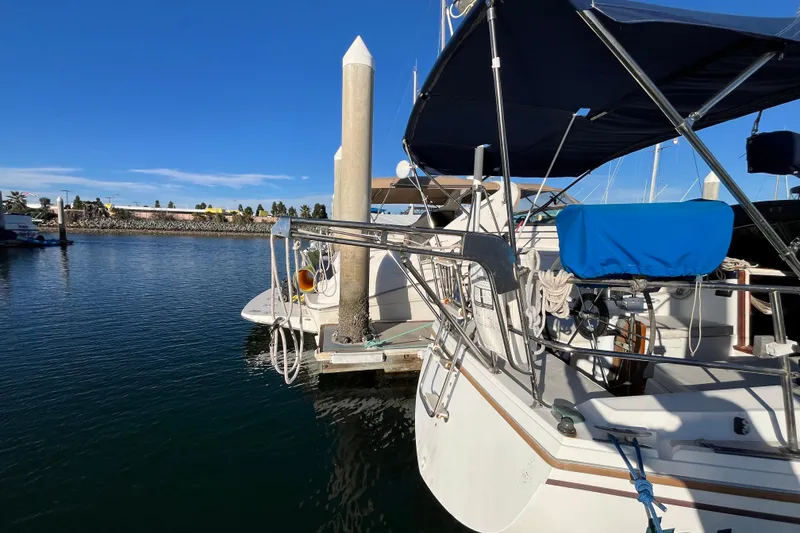 Slide: The Image of Catalina 36 MkII sailboat docked at marina, 1984 model, with blue canopy. - 4