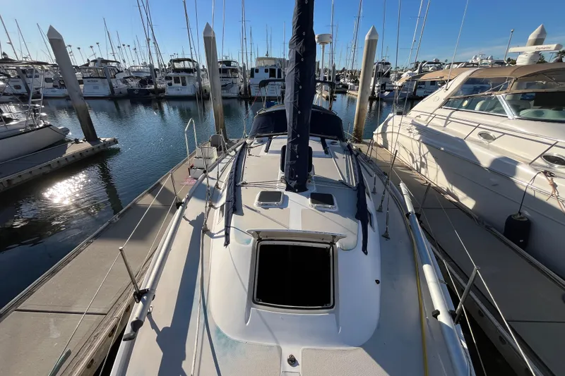 Slide: The Image of 1984 Catalina 36 MkII sailboat docked in a marina, surrounded by other boats. - 7