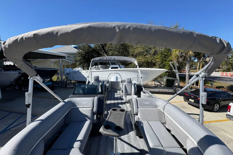 Slide: The Image of 2026 Bennington 23 MFB pontoon boat with spacious seating and canopy in a marina setting. - 23
