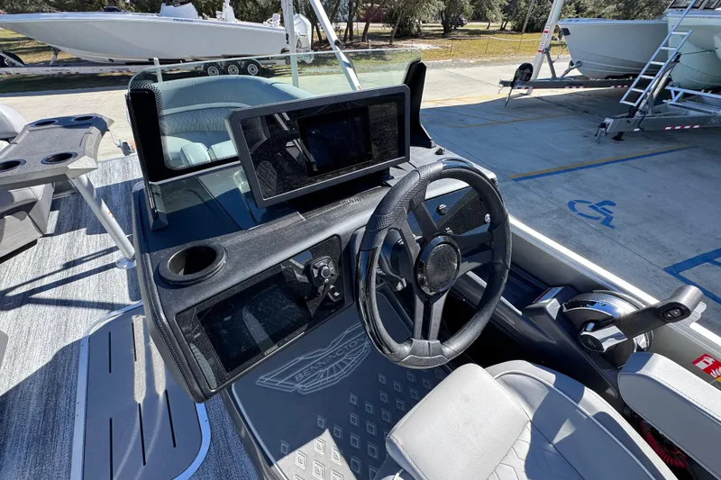 Slide: The Image of 2026 Bennington 23 MFB boat cockpit with steering wheel and control panel. - 26