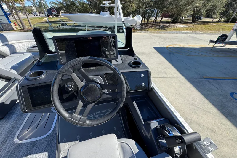 Slide: The Image of 2026 Bennington 23 MFB boat dashboard with steering wheel and control panel. - 27