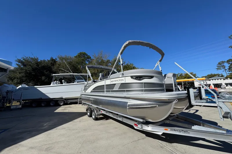 Slide: The Image of 2026 Bennington 23 MFB pontoon boat on trailer under clear blue sky. - 8