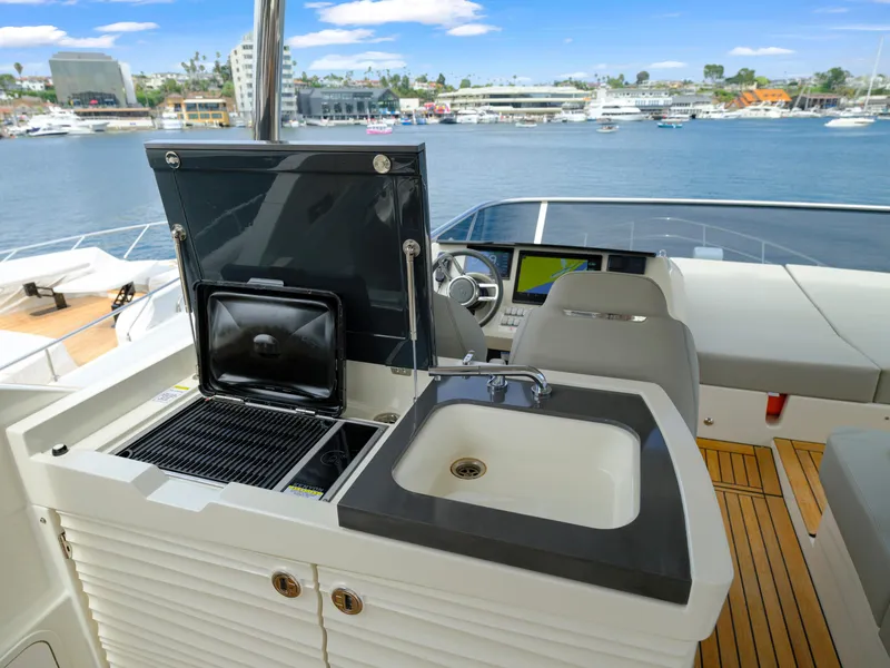 Slide: The Image of Outdoor kitchen and helm station on 2024 Absolute 60 Fly yacht with waterfront view. - 18