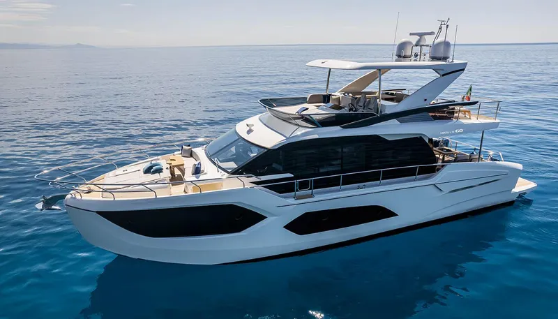 Slide: The Image of 2024 Absolute 60 Fly luxury yacht cruising on calm blue waters. - 2