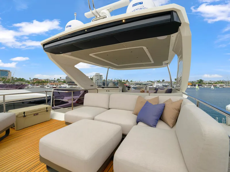Slide: The Image of Luxurious outdoor seating on the 2024 Absolute 60 Fly yacht with scenic marina views. - 27