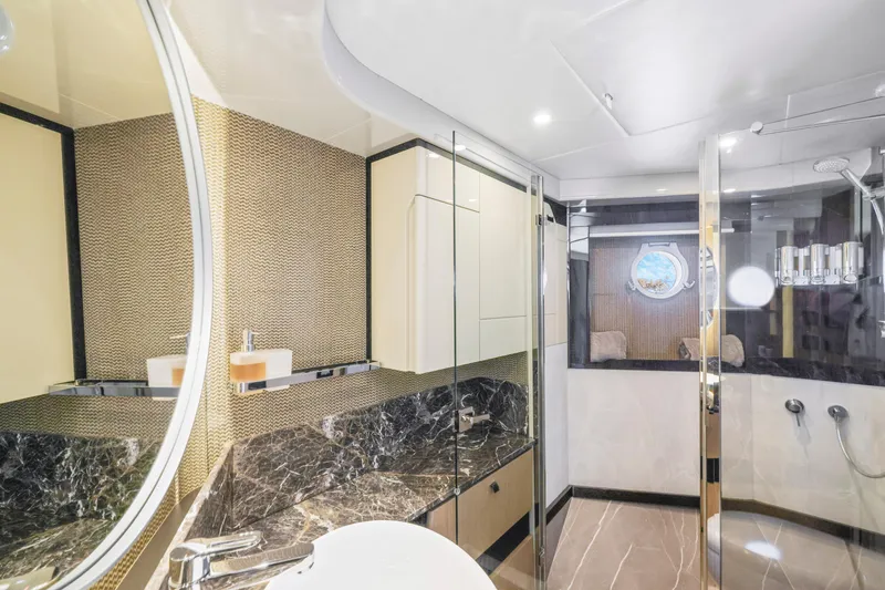 Slide: The Image of Luxurious bathroom in the 2024 Absolute 60 Fly yacht with marble countertops and modern fixtures. - 42