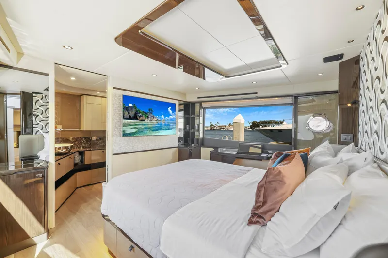 Slide: The Image of Luxurious master bedroom on the 2024 Absolute 60 Fly yacht with modern decor and scenic views. - 46