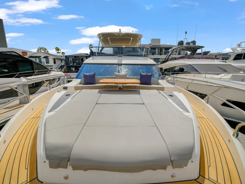 Slide: The Image of 2024 Absolute 60 Fly yacht with sun deck and luxurious seating at marina. - 6