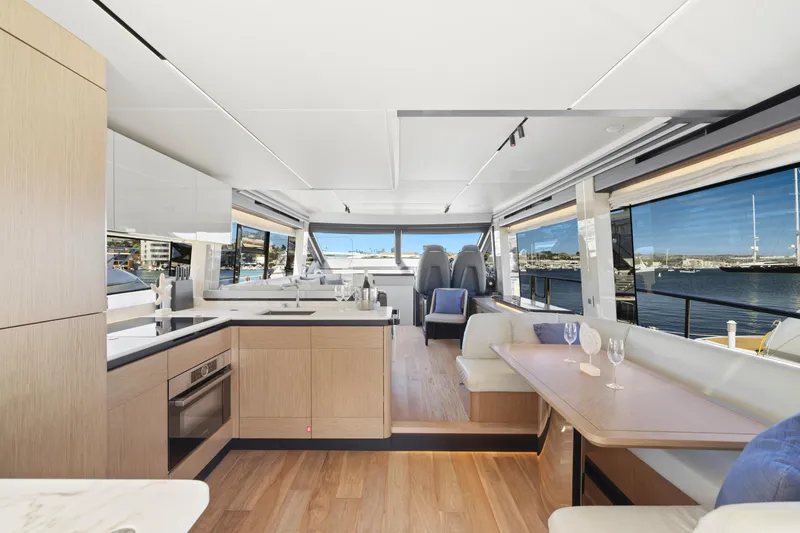 Slide: The Image of 2024 Absolute 60 Fly yacht interior with modern kitchen and dining area. - 29