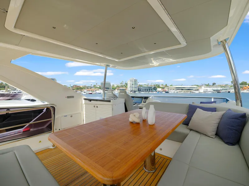 Slide: The Image of Luxurious 2024 Absolute 60 Fly yacht with spacious outdoor seating and dining area. - 12