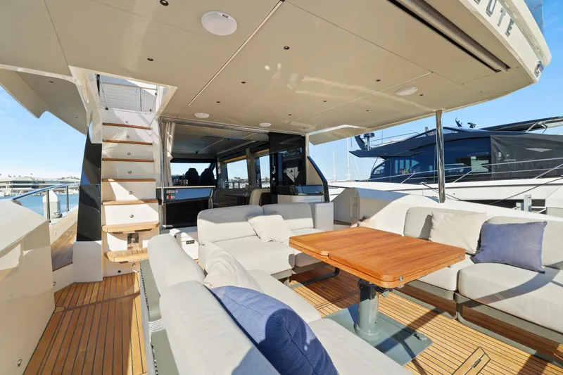 Slide: The Image of 2024 Absolute 60 Fly yacht with spacious outdoor seating and dining area. - 16