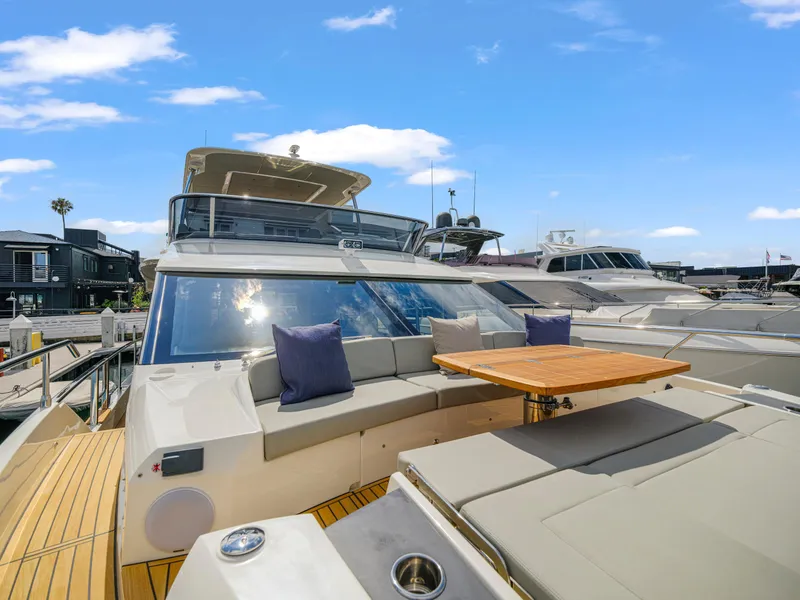 Slide: The Image of 2024 Absolute 60 Fly yacht with spacious deck and seating area. - 9